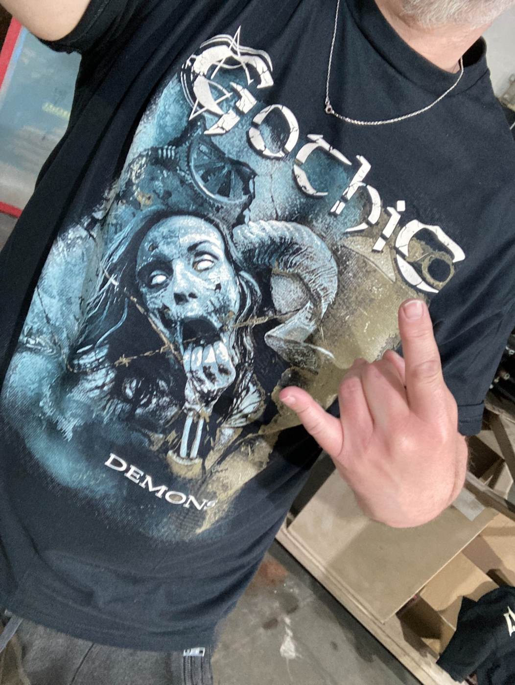 Person wearing a custom printed black heavy metal band T-shirt