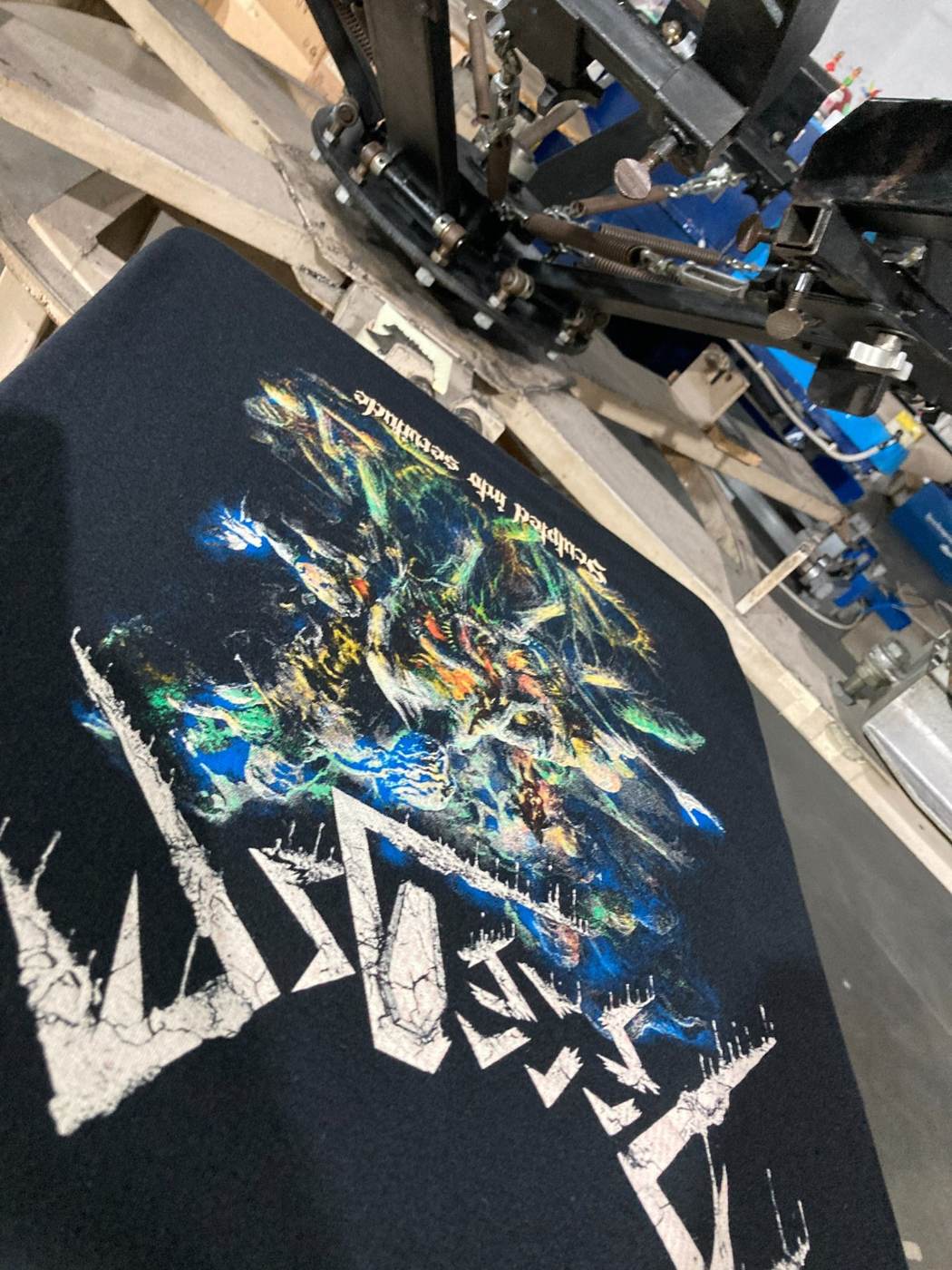 Colorful custom metal band artwork freshly screen printed on black fabric